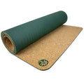 Original cork yoga mat in forest-green lying flat on a studio floor.