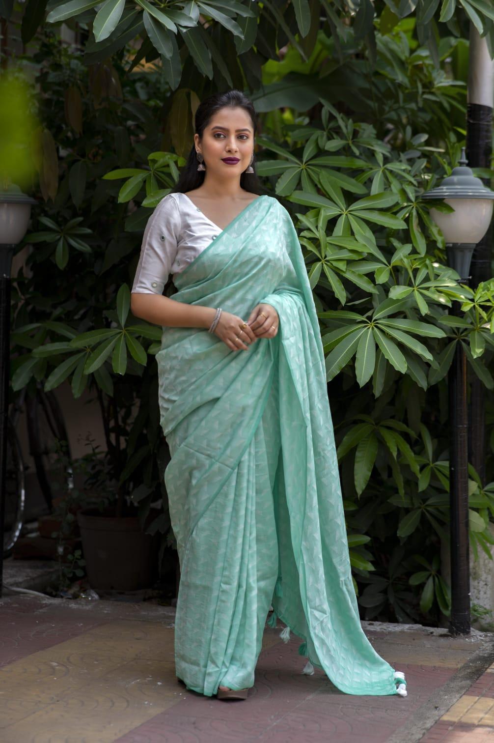 Green poly georgette saree with leaf woven pattern and mirror work blouse