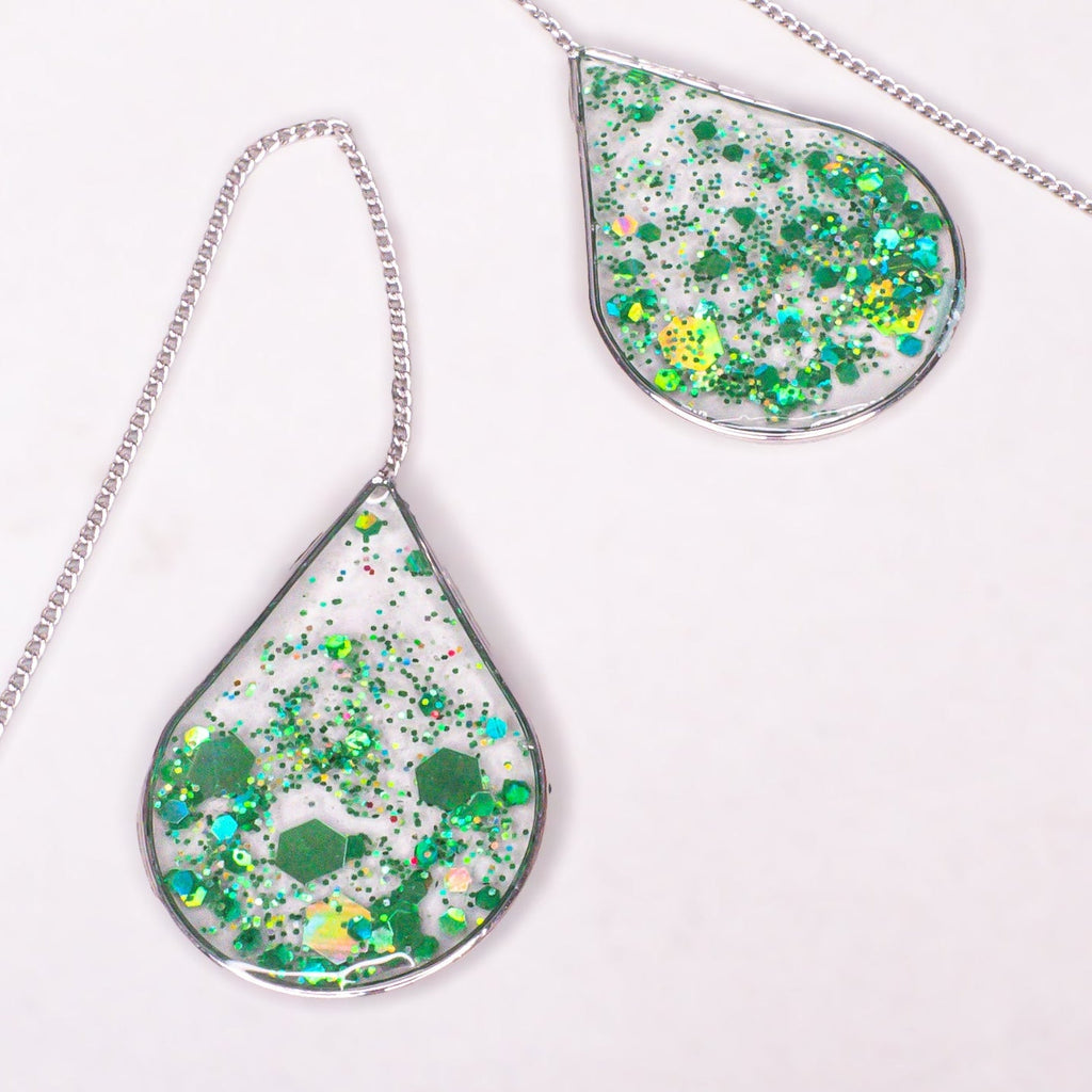 Close-up of Ngọc Lục Green Glitter Silver Threader earrings featuring elegant, adjustable design