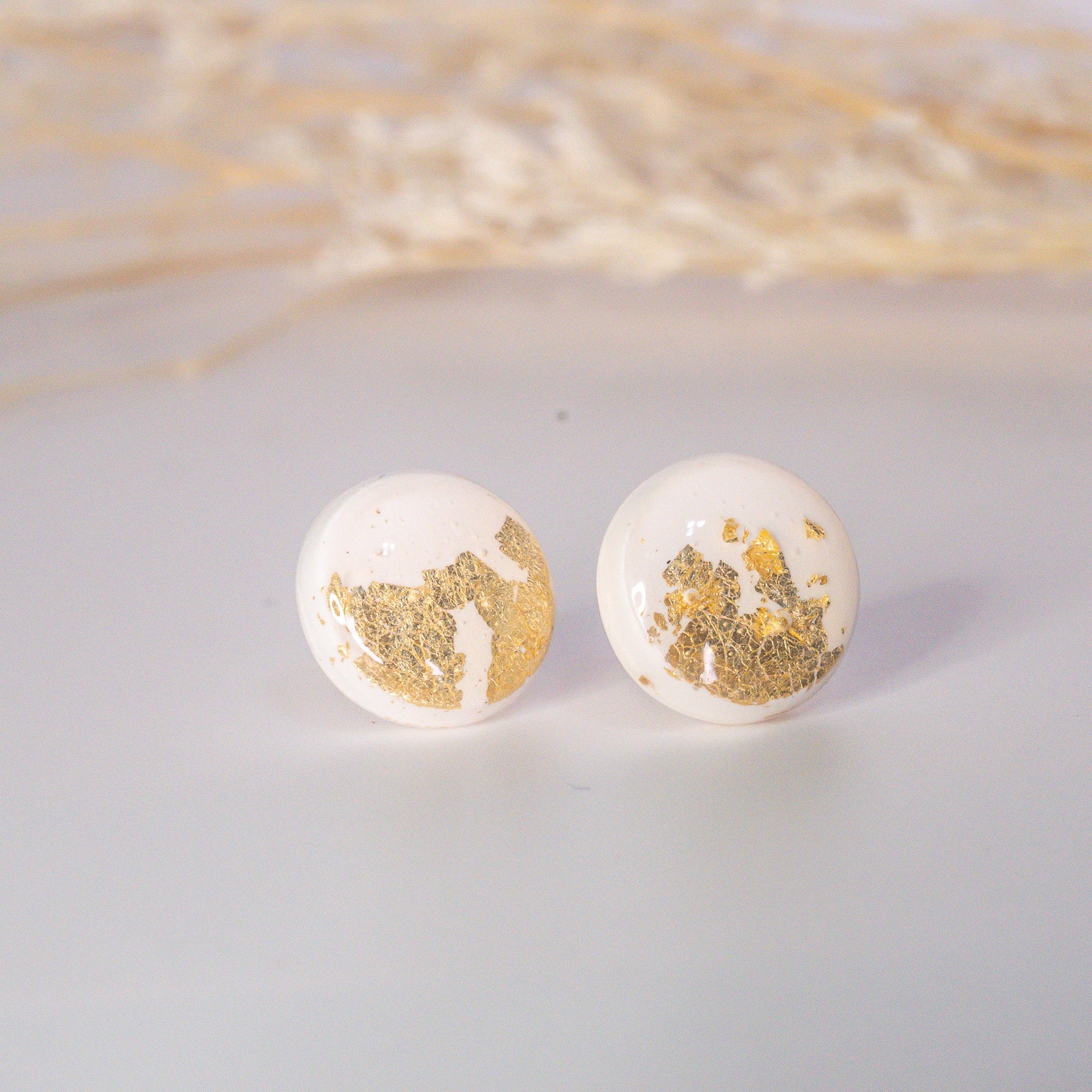 Ngọc Nắng white minimalist stud earrings with gold flakes