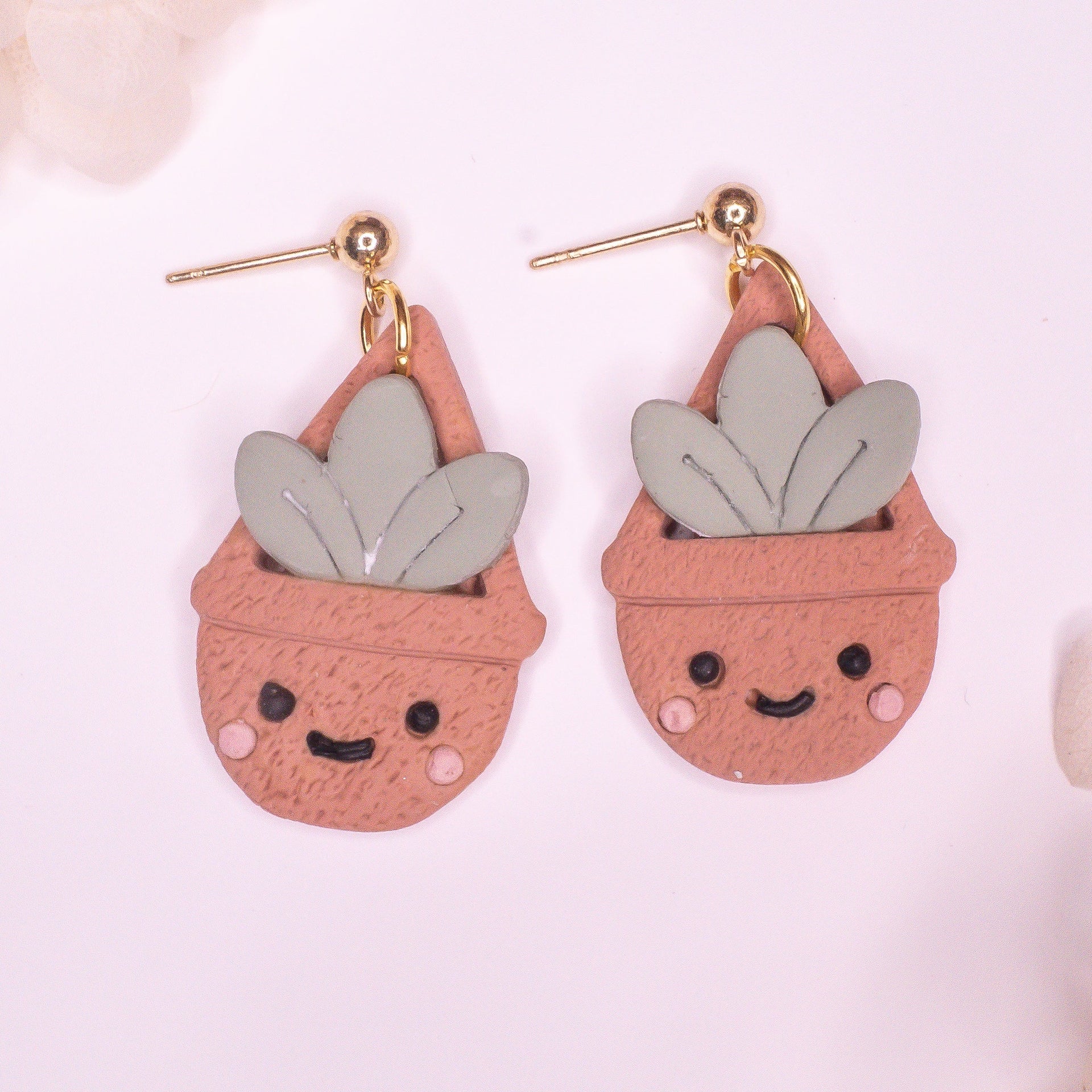 Handmade Happy Hanging Succulent earrings featuring sage green leaves in terracotta pots with gold-plated hooks.