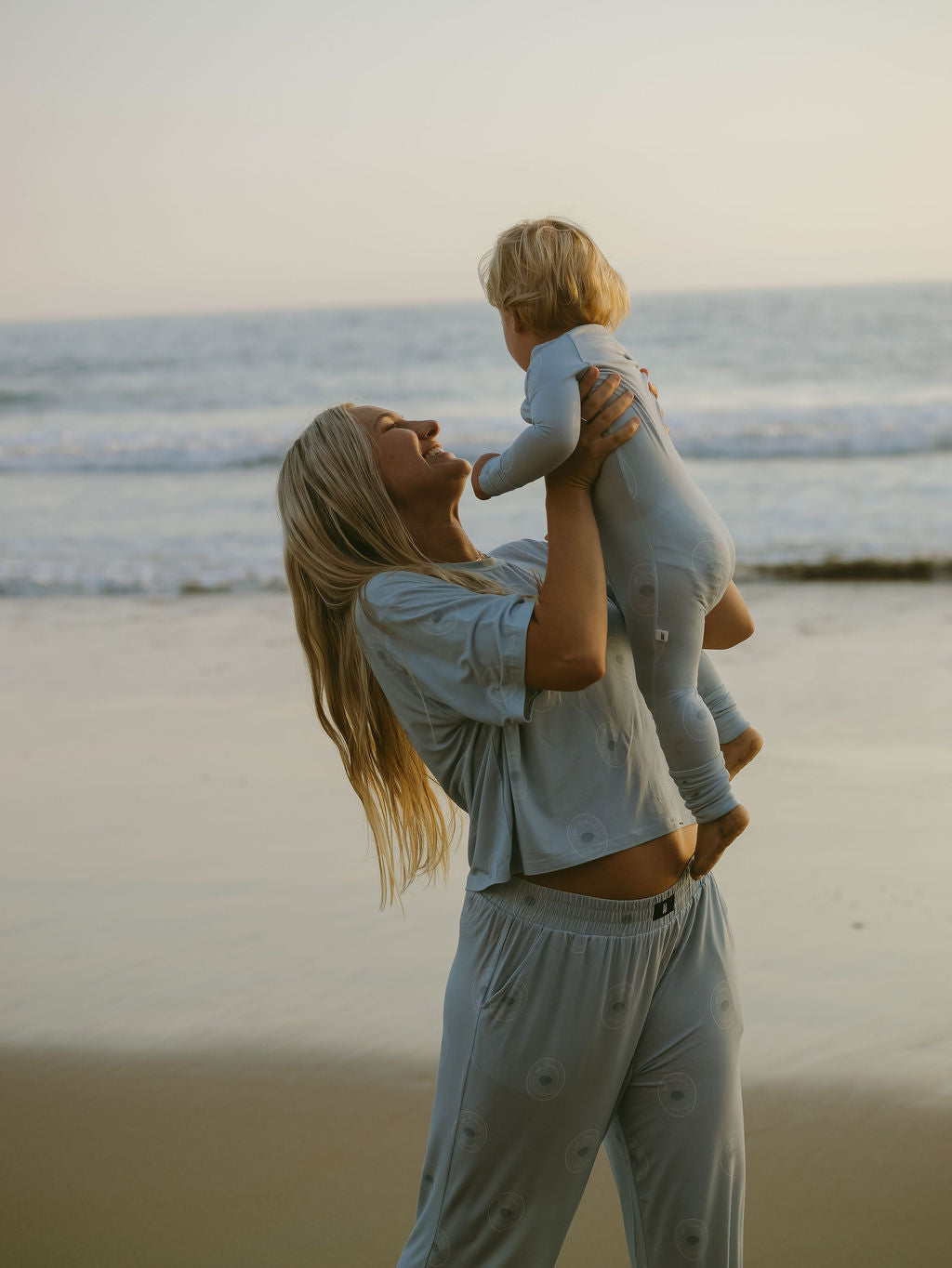 Woman wearing a relaxed-fit boxy tee and matching wide-leg lounge pants in light blue
