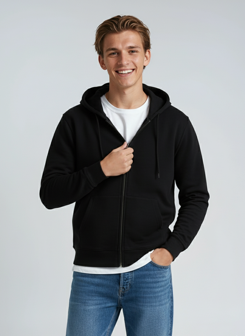 A man wearing a black midweight zip-up hoodie layered over a white t-shirt.