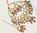 Exquisite handmade gold-plated Kundan jewellery set featuring vibrant red stones