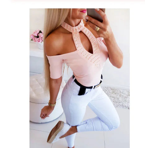 Model wearing a fitted off-shoulder top with a studded cutout neckline