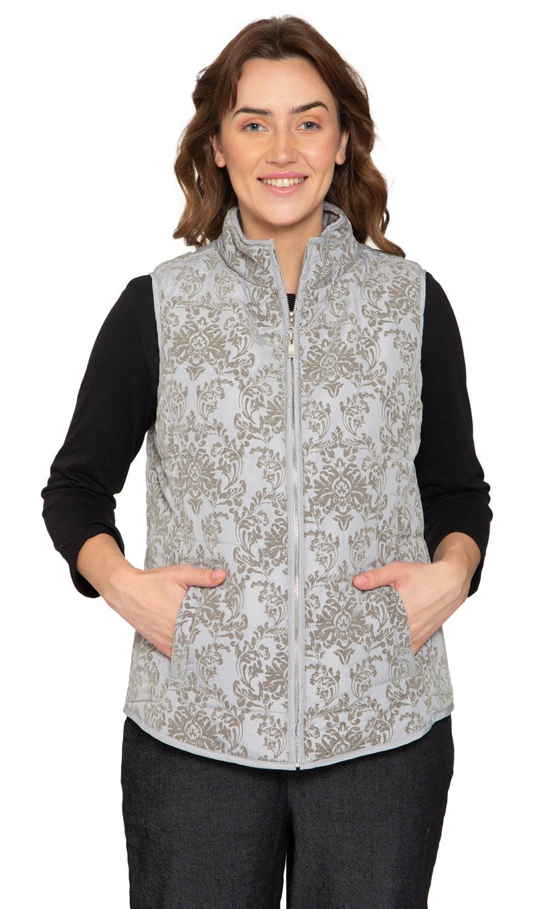 Women wearing a flocked damask print zip-front vest in light-grey over a long-sleeve top.