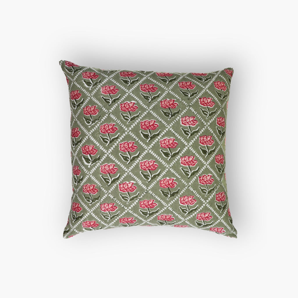 Hand-block printed olive green and pink floral linen throw pillow cover on a neutral sofa.
