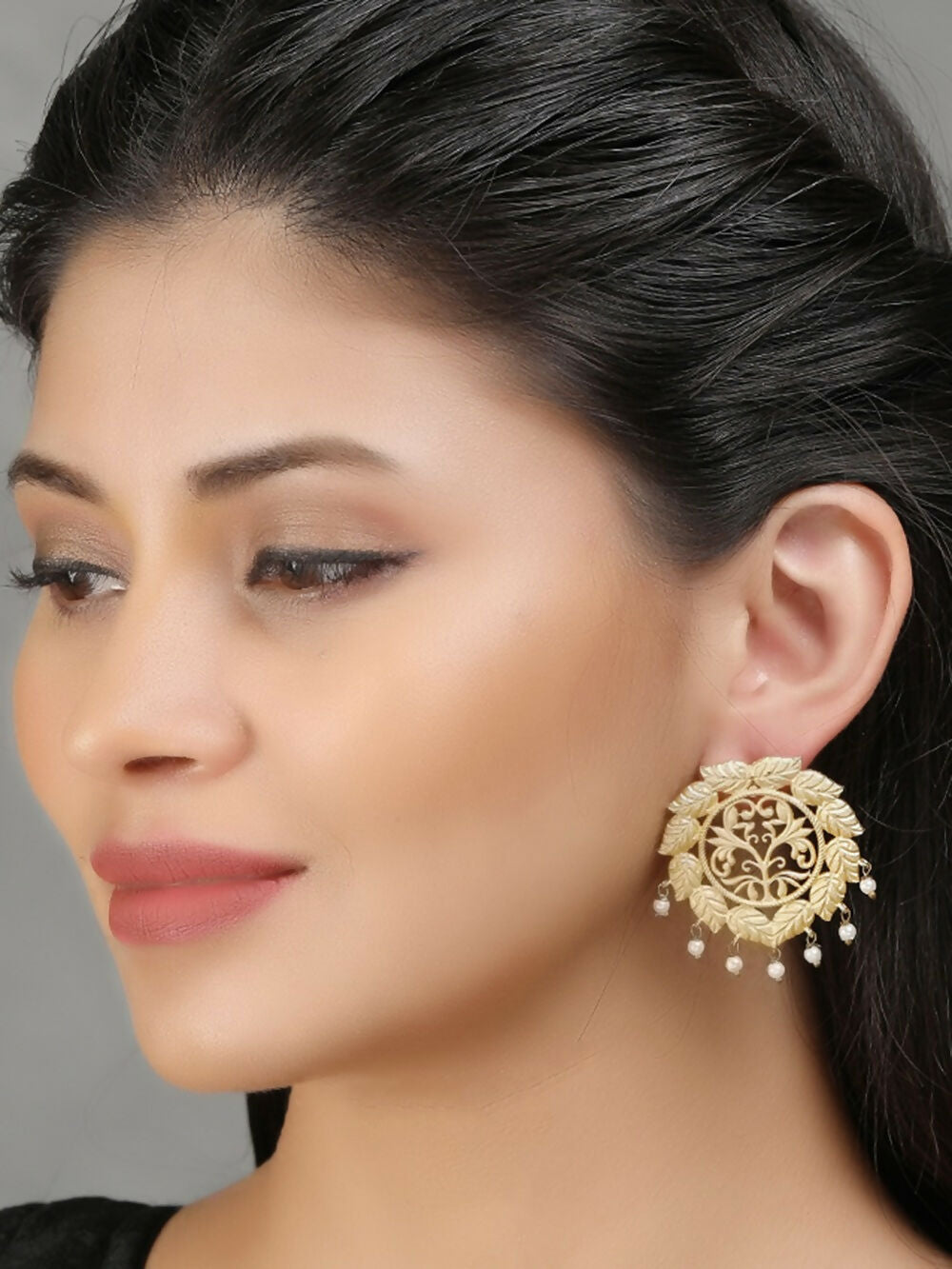 Handcrafted matte gold earrings featuring an elegant, artistic design.