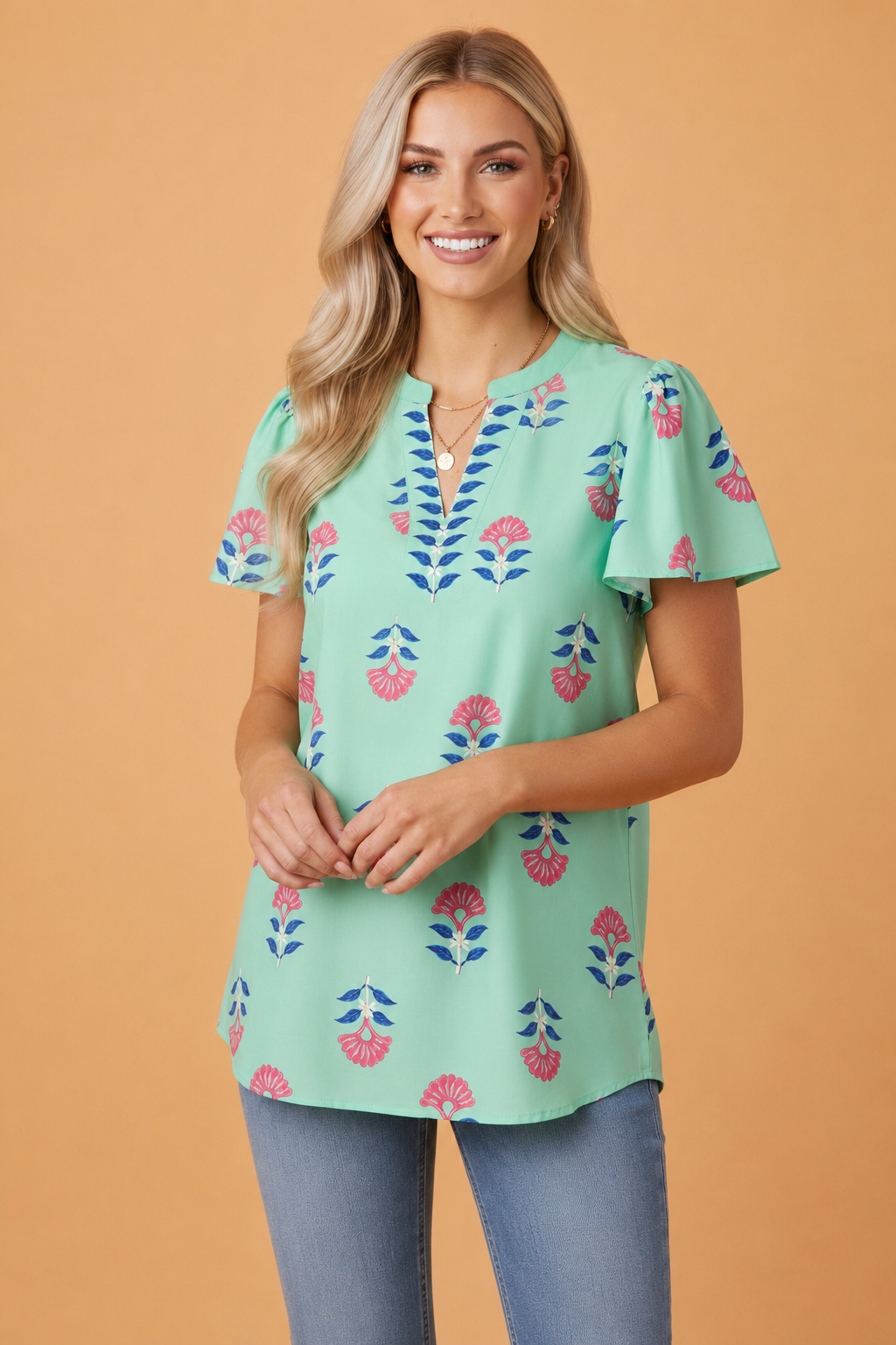 A floral print V-neck blouse with flutter sleeves in mint green, pink, and navy blue.
