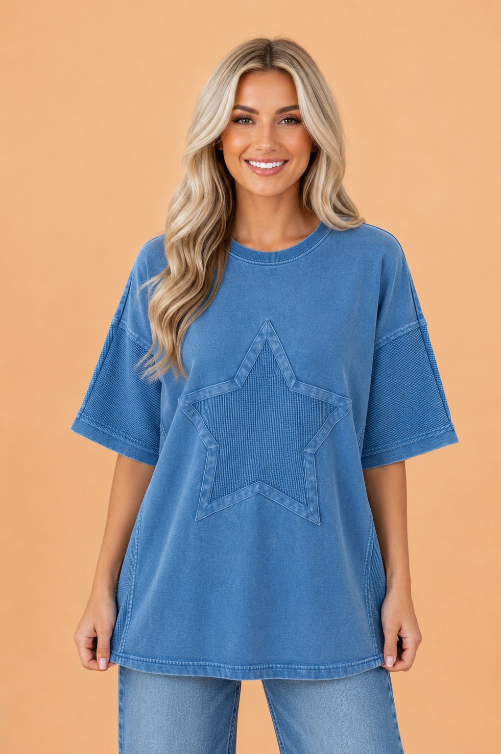 Woman wearing an oversized blue mineral wash waffle knit tee with star patch embroidery