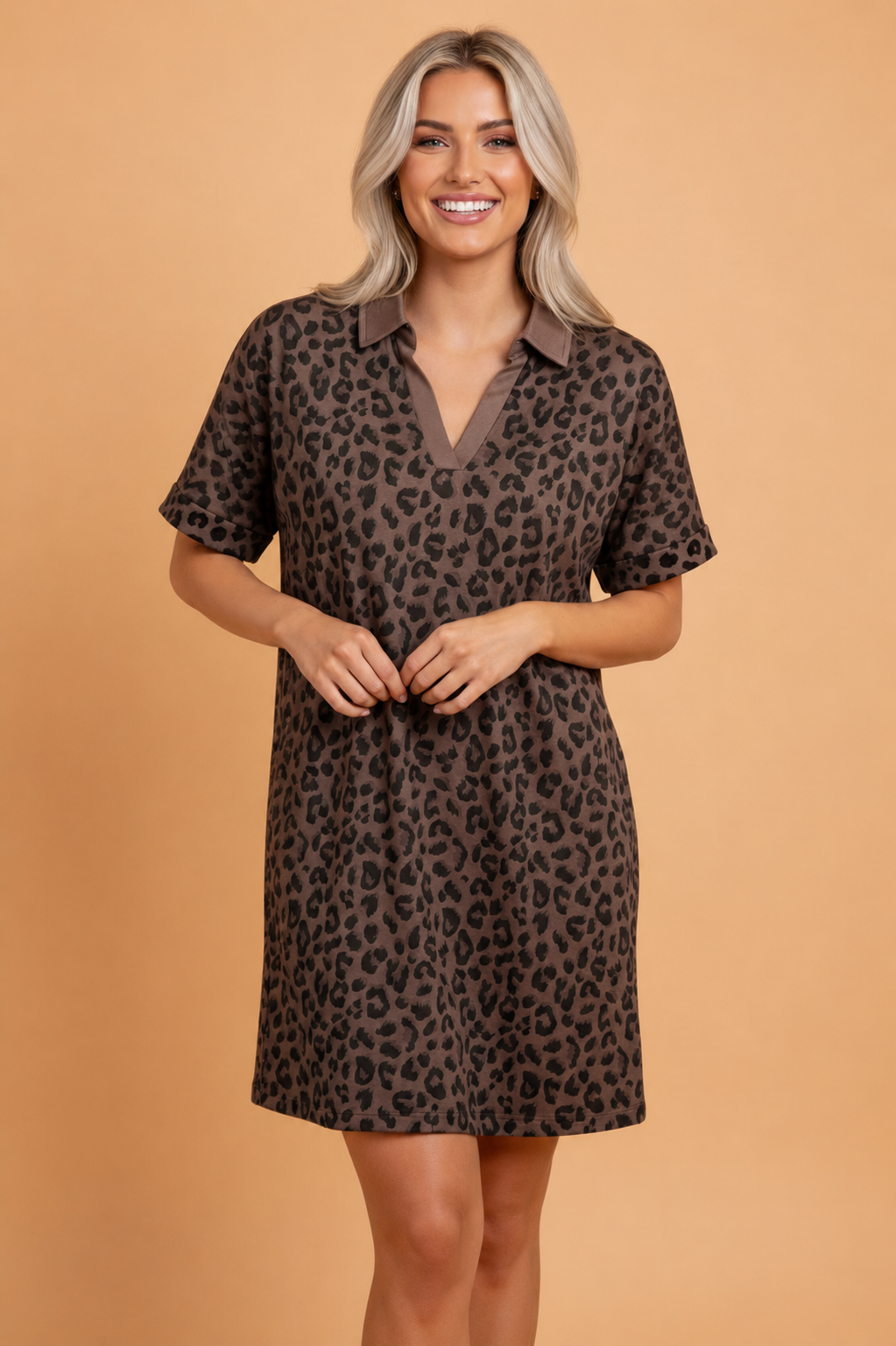 Model wearing a brown and black leopard print mini dress with a contrast polo collar and rolled short sleeves.
