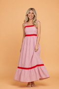 Red and white striped cotton maxi dress featuring bow-tie straps and a ruffle hem