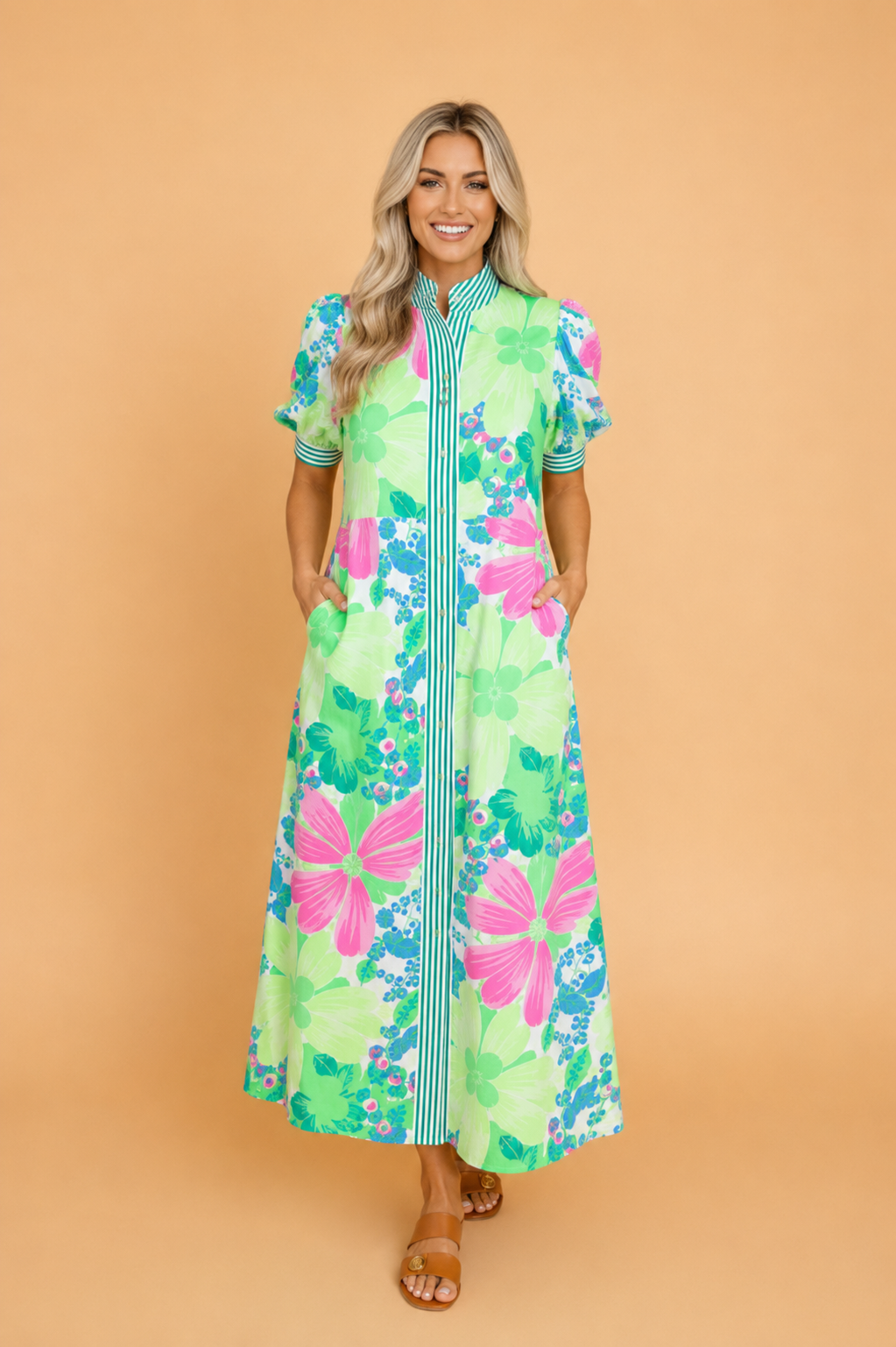 A floral button-down vacation dress featuring a stand collar and contrast stripe trim on short sleeves.