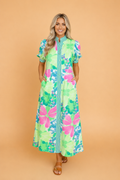 A floral button-down vacation dress featuring a stand collar and contrast stripe trim on short sleeves.