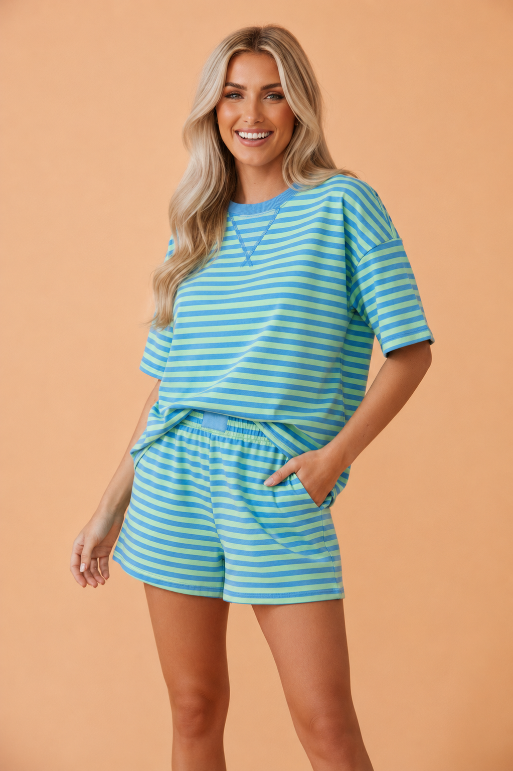 Women wearing a vibrant striped cotton short sleeve crew neck top and matching high-waist elastic shorts loungewear set.