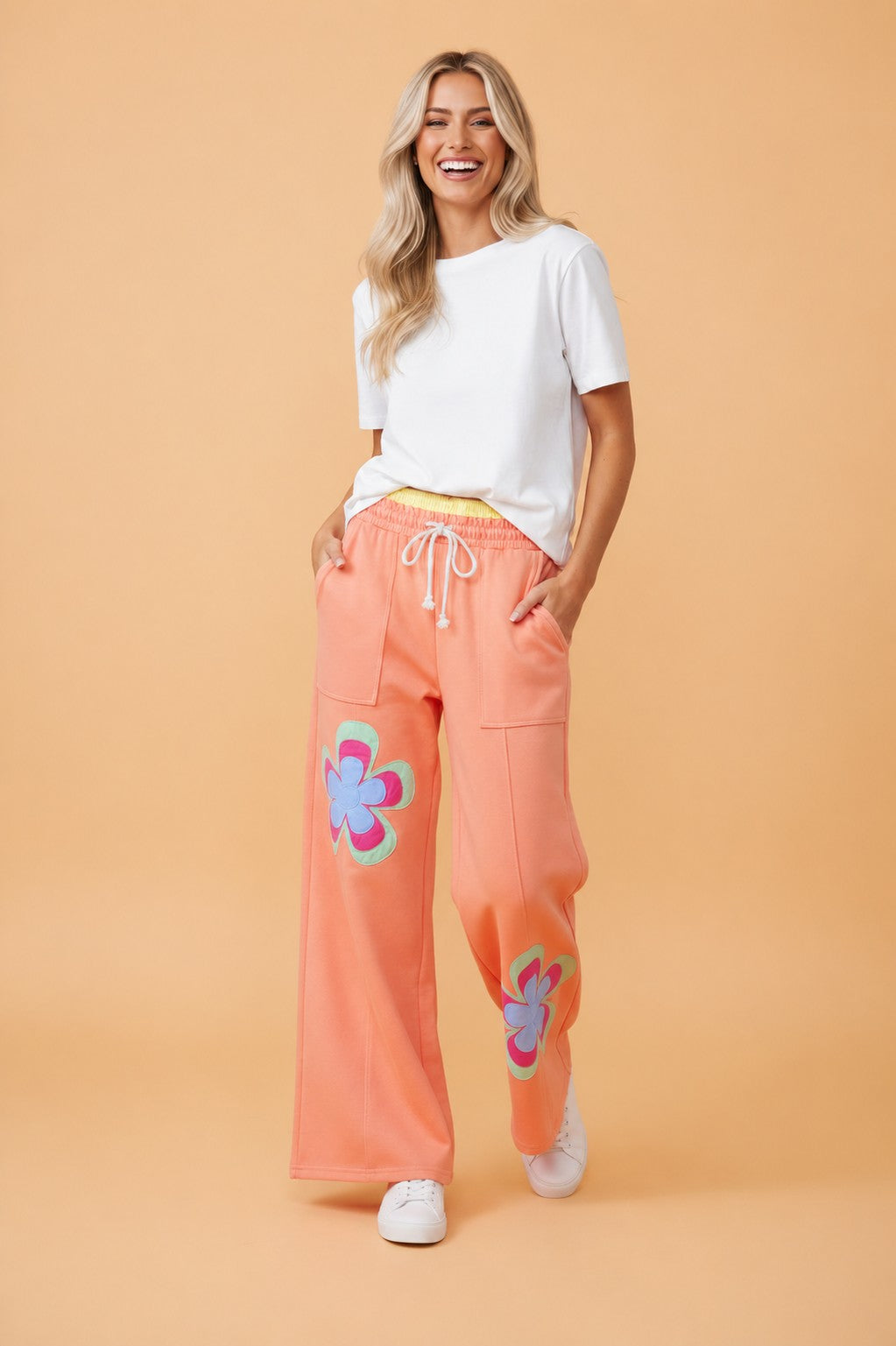 Women wearing floral patchwork colorblock wide leg pants with a drawstring waist