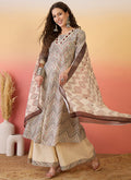 Elegant cream Roman silk embroidered A-line kurta paired with palazzo pants and dupatta.