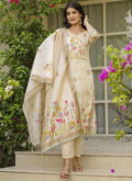 Woman wearing a cream viscose silk designer suit with gota patti and embroidery work