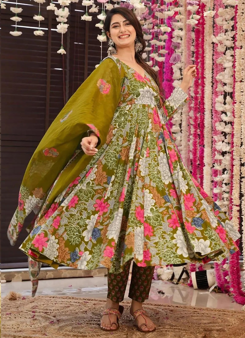 Woman wearing a Mehendi colored Muslin printed designer palazzo suit with gold gota patti embroidery