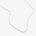 A classic, high-shine sterling silver chain necklace worn solo against a neutral background.