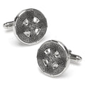 A pair of round silver Celtic cross cufflinks with intricate black etched knotwork details against a white background.