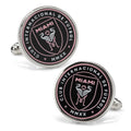 A pair of round Inter Miami CF logo cufflinks featuring a black and pink enamel design on silver plated metal.