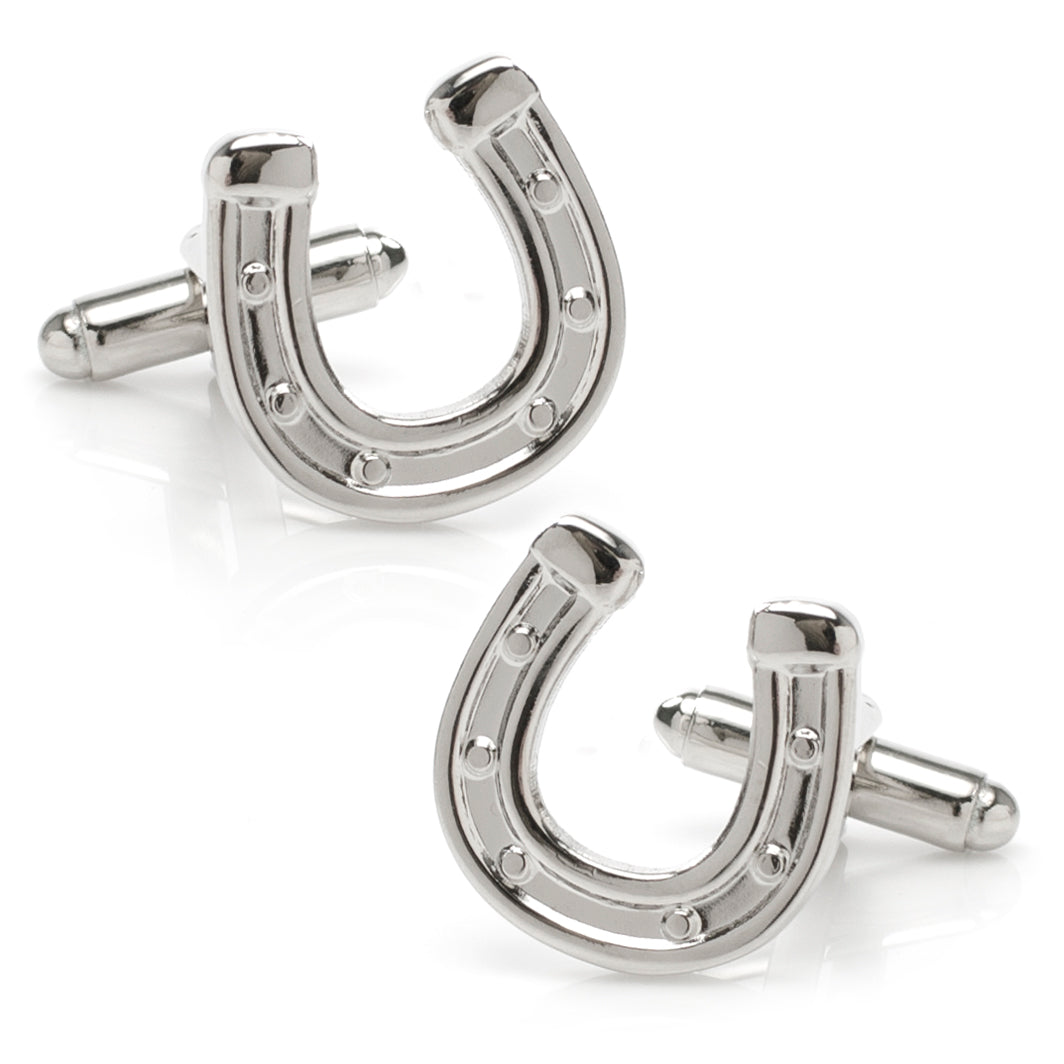 Silver tone horseshoe shaped cufflinks on a white background