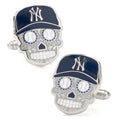 A pair of New York Yankees sugar skull cufflinks with blue caps and baseball eyes on a white background.
