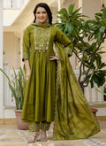 Woman wearing a Mehendi green Viscose Roman Silk kurta with intricate mirror handwork and gold embroidery.