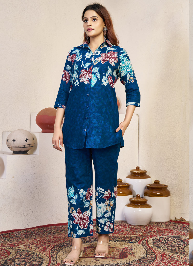 Woman wearing a blue pure cotton co-ords set with stylish prints and handwork on the neckline.