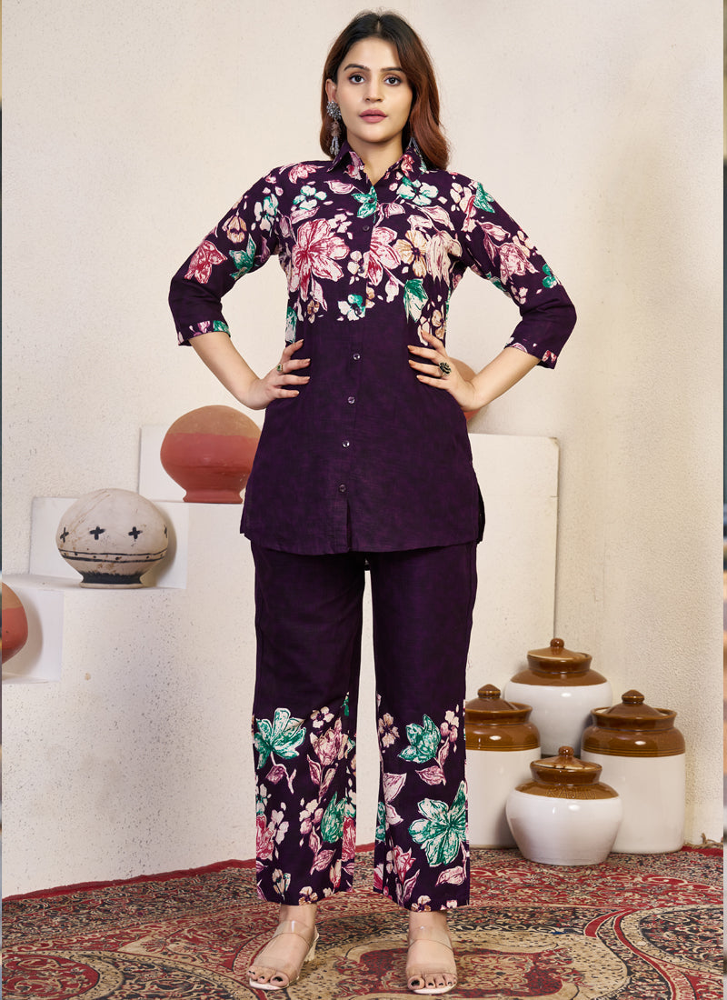 Woman wearing a violet pure cotton co-ord set with floral prints and a collared neckline.