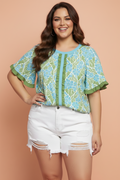 Vibrant floral print blouse with ruffled sleeves and blue/green colorblock trim.