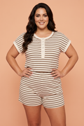 Woman wearing a cream and brown striped knit short-sleeve top and matching elastic waist shorts set.