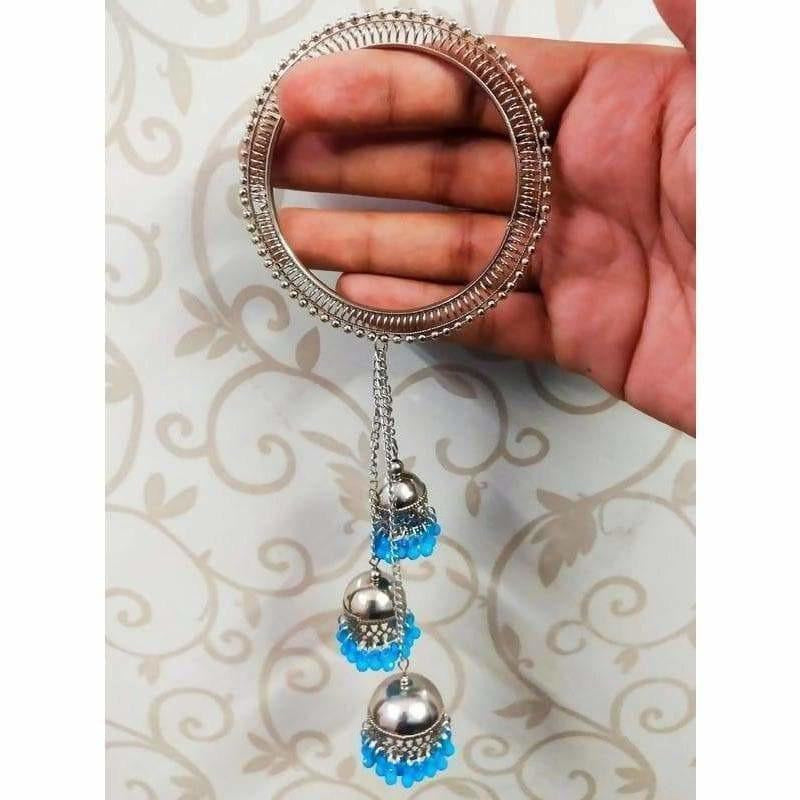 Silver tone bangles featuring blue pearls and dangling jhumka charms for traditional Indian attire