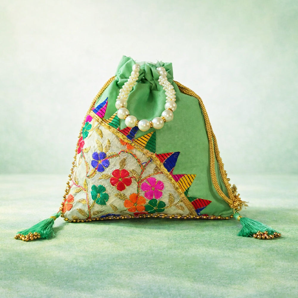 Handcrafted wedding potli bag with intricate embroidery, pearl border, and beaded handle