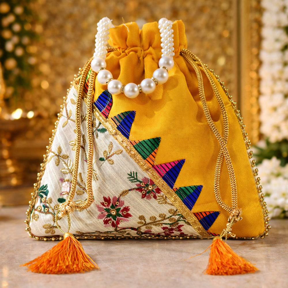 Close-up of a handcrafted wedding potli bag with intricate embroidery, pearl borders, and beaded handle.