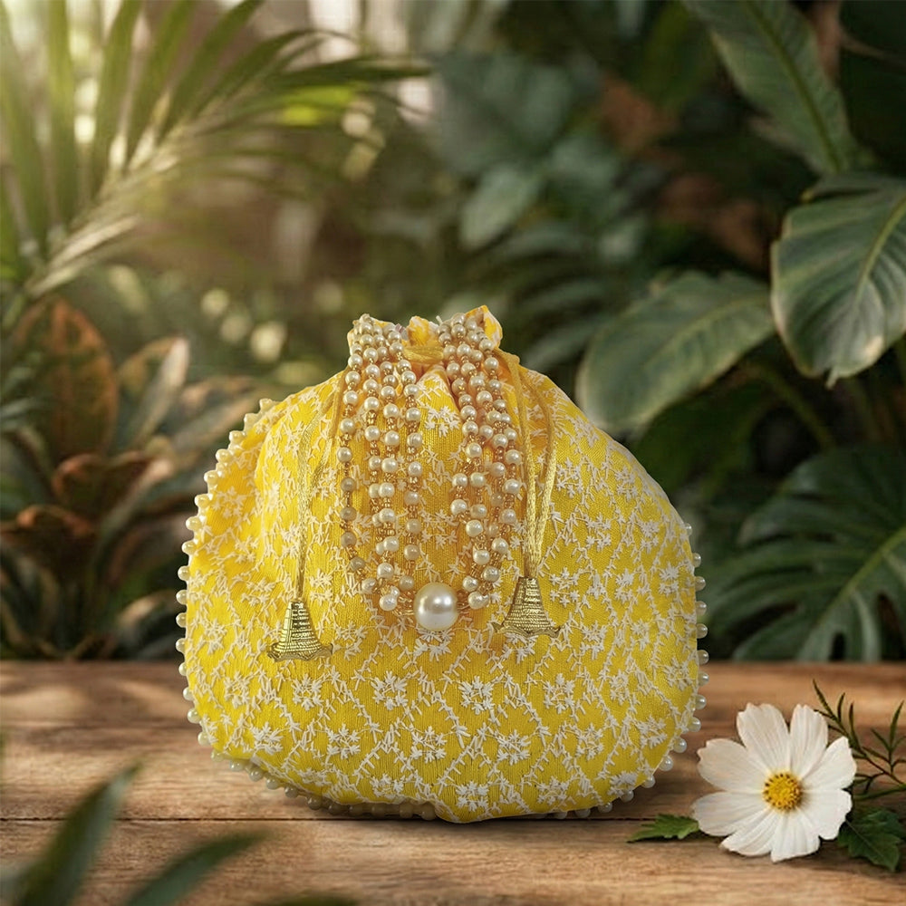 Handcrafted silk brocade potli bag with intricate embroidery and beadwork for bridal and wedding wear