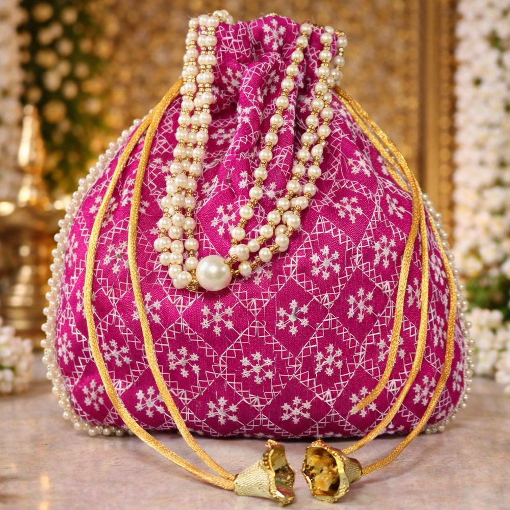 A handcrafted embroidered silk brocade potli bag featuring pearl borders and beaded handles for wedding occasions.