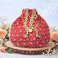 Handcrafted silk brocade wedding potli bag with pearl trim and beaded handle