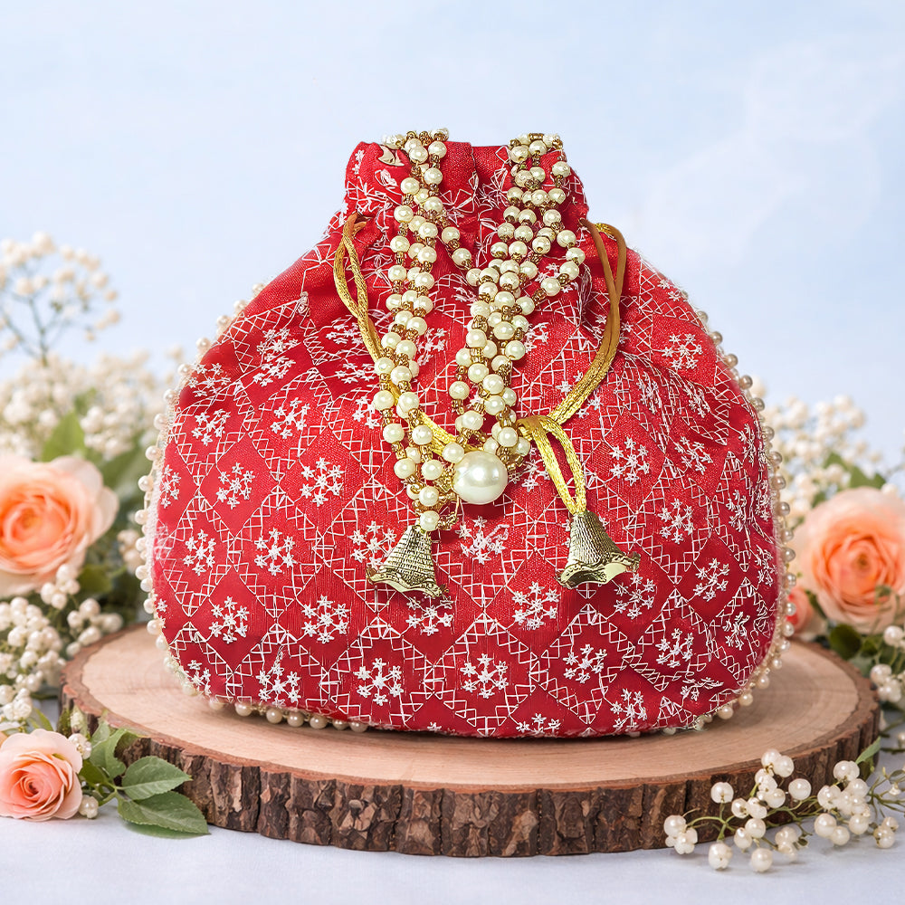 Handcrafted silk brocade wedding potli bag with pearl trim and beaded handle