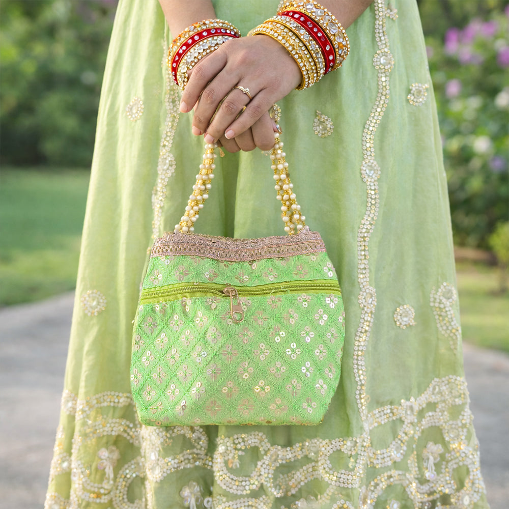 Elegant silk brocade potli bag with pearl border and drawstring closure for weddings and festive occasions