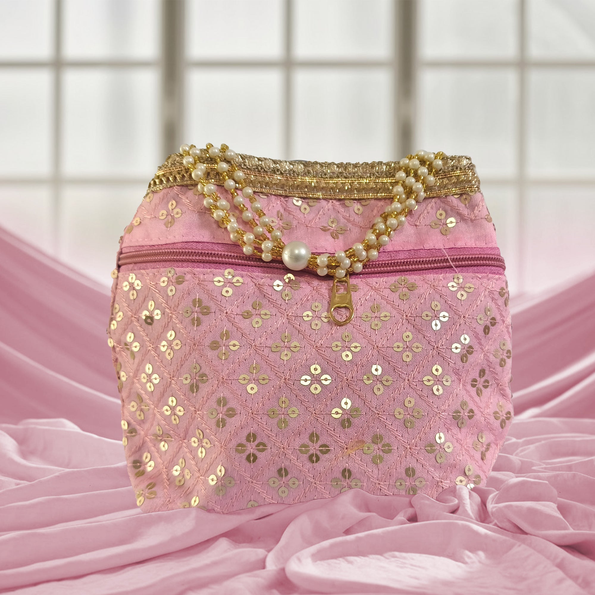 Silk brocade potli bag with pearl borders, beaded handles, and intricate embroidery for wedding occasions