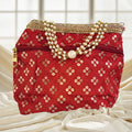 Luxurious silk brocade potli bag with pearl borders and beaded handle for weddings