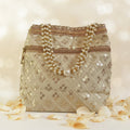 Luxurious silk brocade wedding potli bag with pearl borders and beaded handles