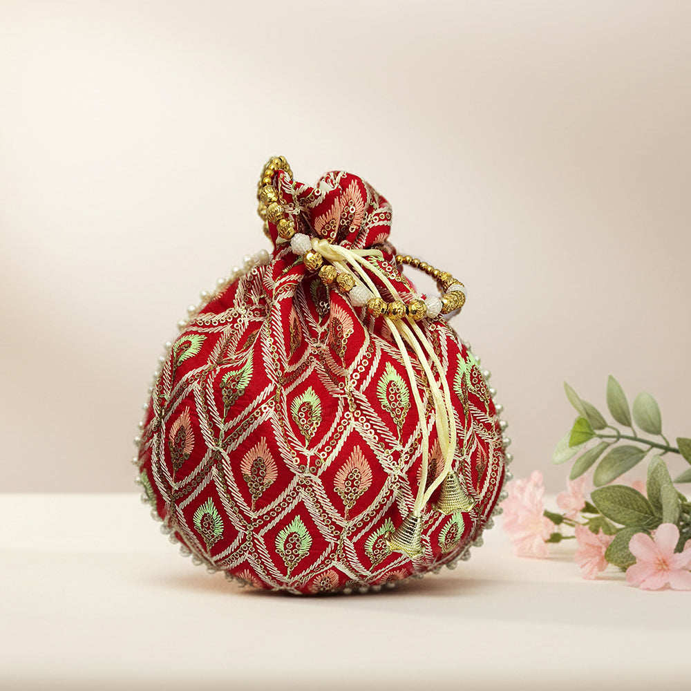 Embroidered silk brocade potli bag with intricate beadwork and drawstring closure, ideal for formal weddings