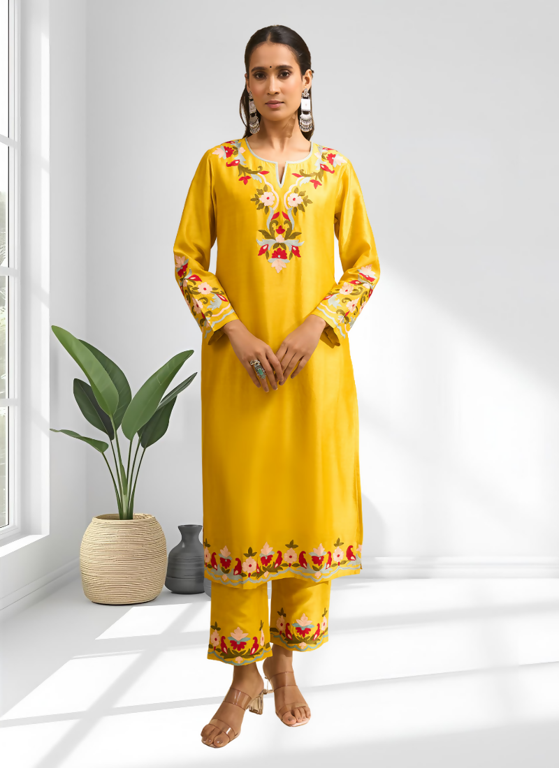 Vibrant yellow silk long kurta with detailed embroidery and matching pant for festive wear.