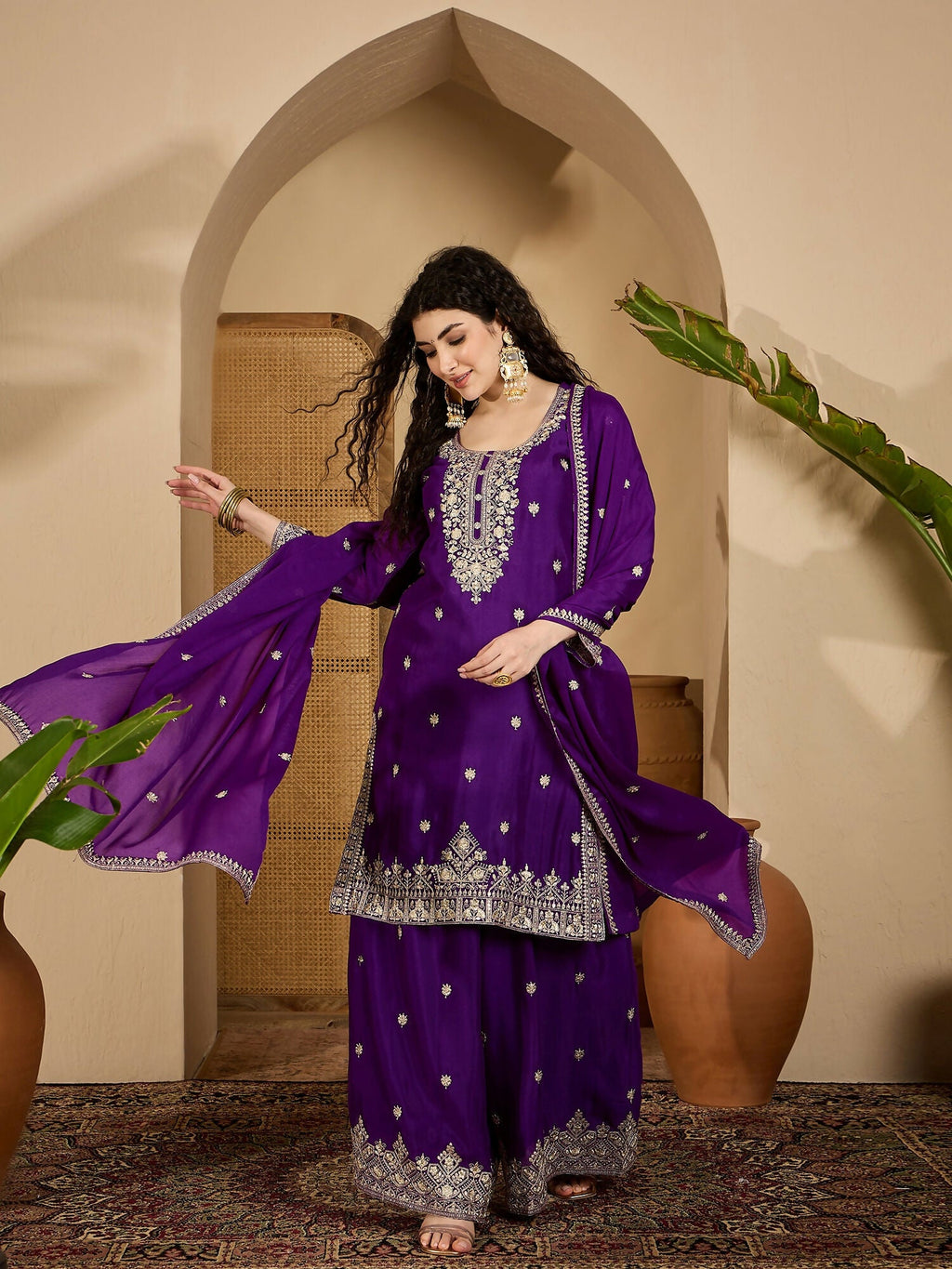 Model wearing a purple Chinon Silk embroidered kurta set with 3/4 sleeves and a round neck