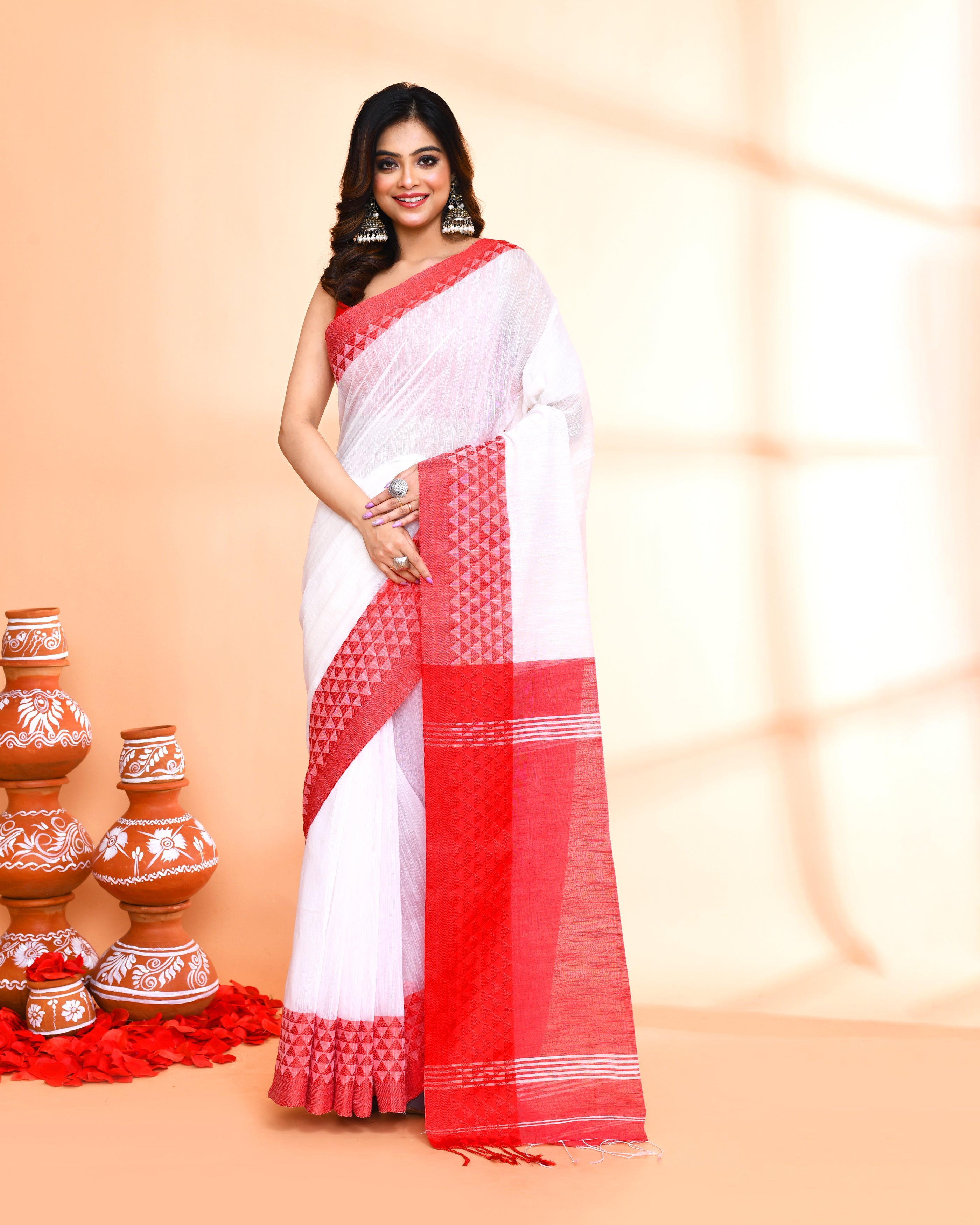 White cotton silk handloom saree with matching blouse piece draped elegantly.
