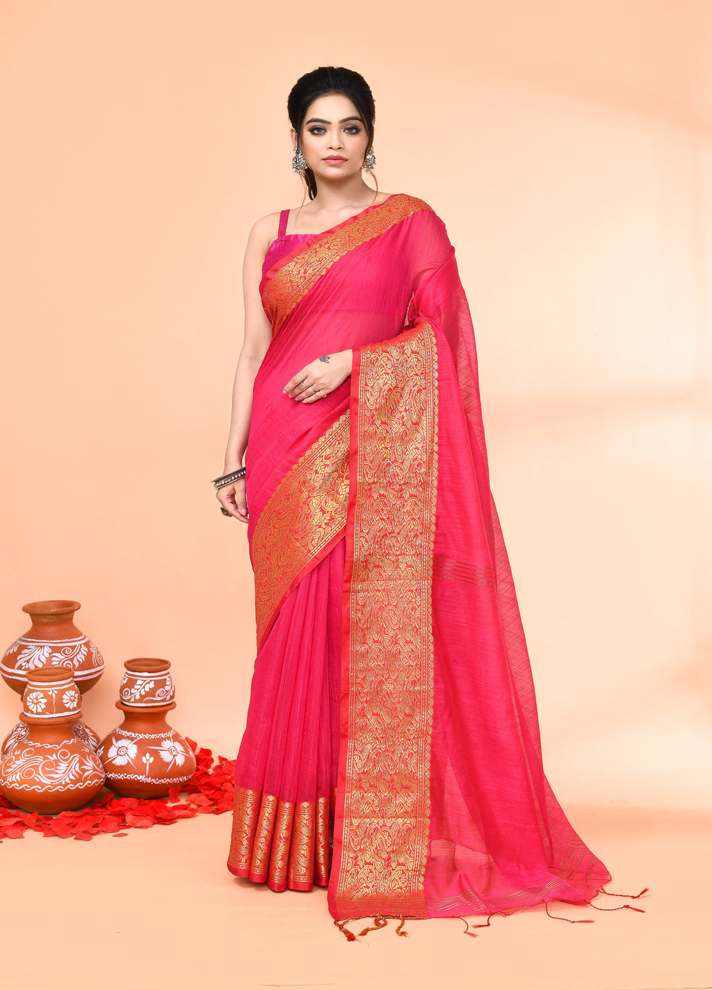 Model wearing a vibrant Rani cotton blend handloom saree with a matching blouse.
