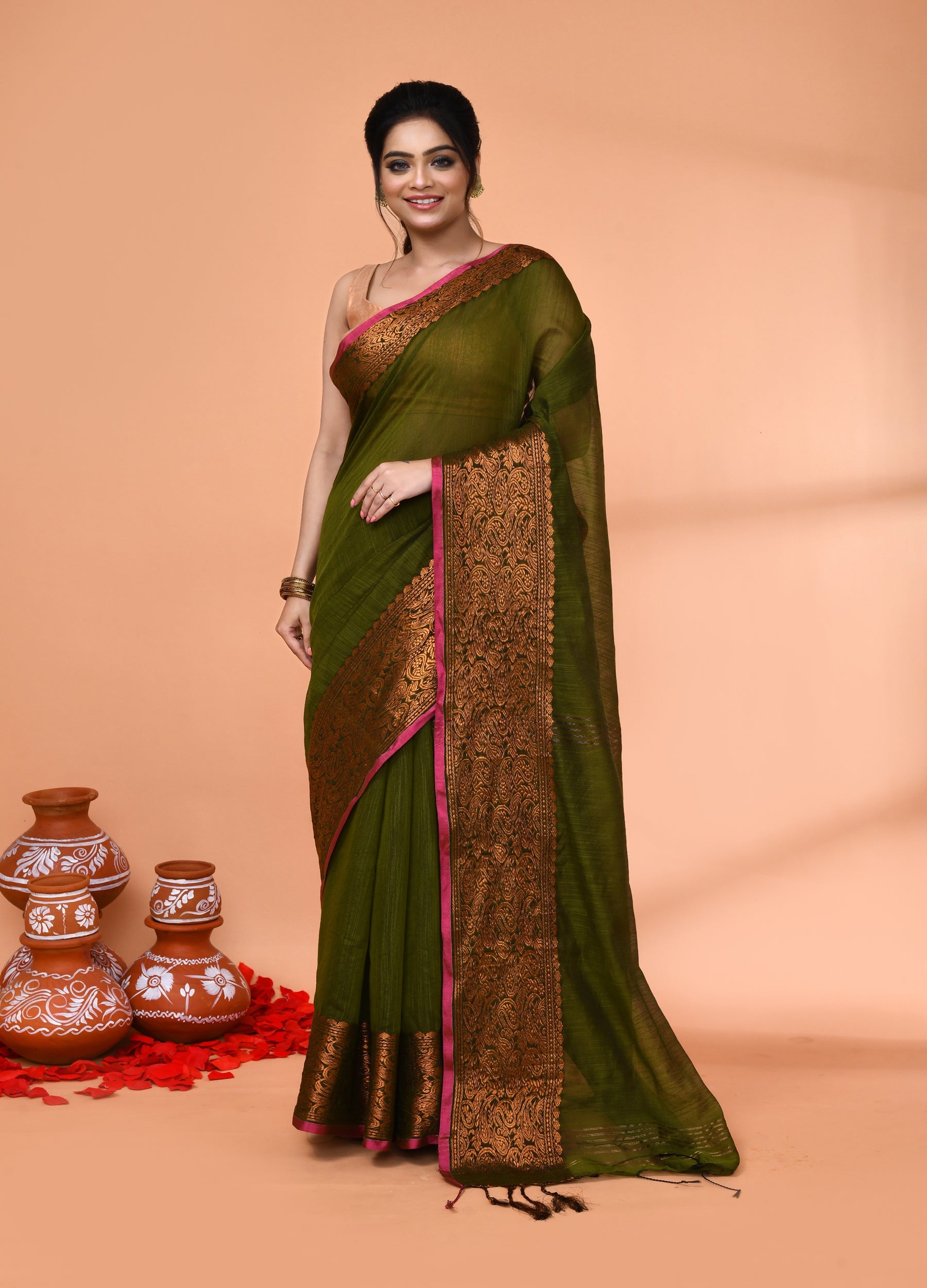 Moss green handloom cotton blend saree with matching blouse piece draped elegantly